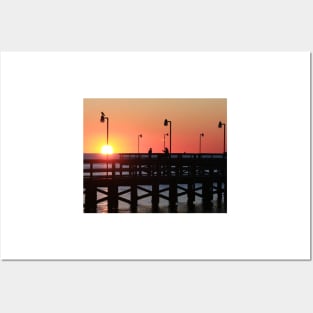 Two fishermen sillouhetted on the pier at sunrise Posters and Art